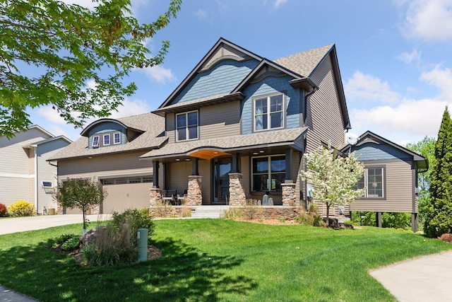craftsman-style home with covered porch, driveway, a front yard, a garage, and a shingled roof