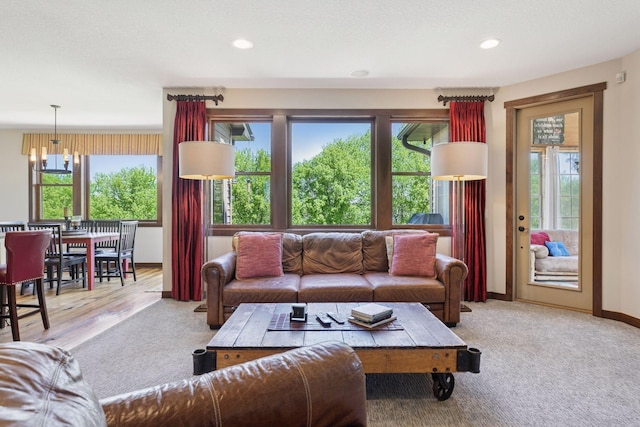 living room with carpet floors, recessed lighting, and baseboards