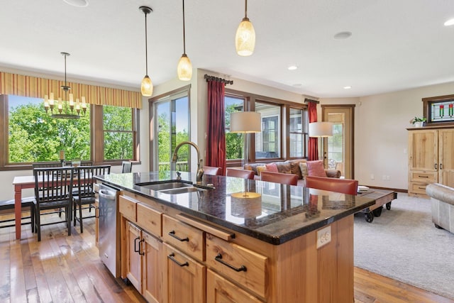 kitchen with a sink, open floor plan, plenty of natural light, light wood-type flooring, and recessed lighting