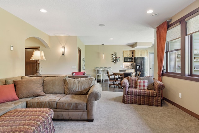 living room with recessed lighting, carpet, and baseboards