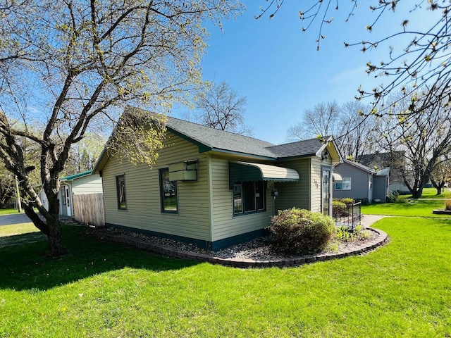 view of home's exterior with a yard