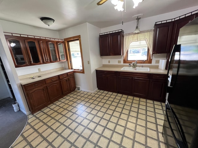 kitchen featuring a sink, light countertops, and plenty of natural light