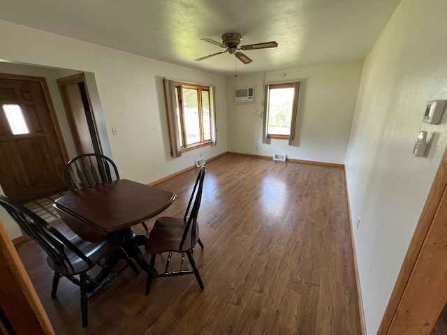 dining space with an AC wall unit, ceiling fan, dark wood-type flooring, and baseboards