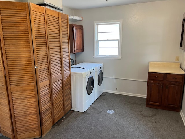 laundry room featuring cabinet space, independent washer and dryer, dark carpet, and baseboards