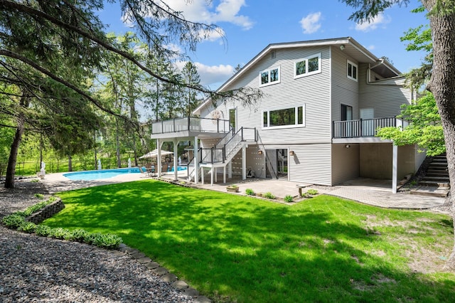 2209 Indian Rd W, Minnetonka, MN 55305 - back of property featuring stairs, a patio area, a deck, a yard, and an outdoor pool