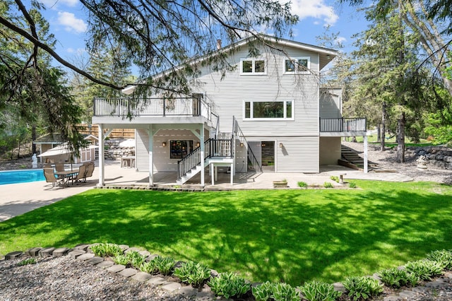 2209 Indian Rd W, Minnetonka, MN 55305 - back of property with stairway, a deck, a patio, and a lawn