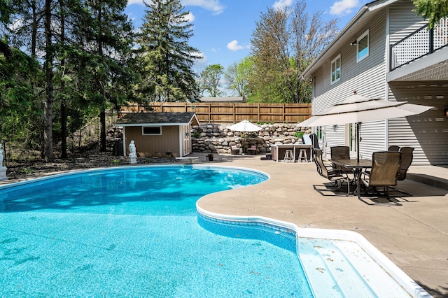 2209 Indian Rd W, Minnetonka, MN 55305 - view of pool with a patio, an outdoor structure, outdoor dining space, and a diving board