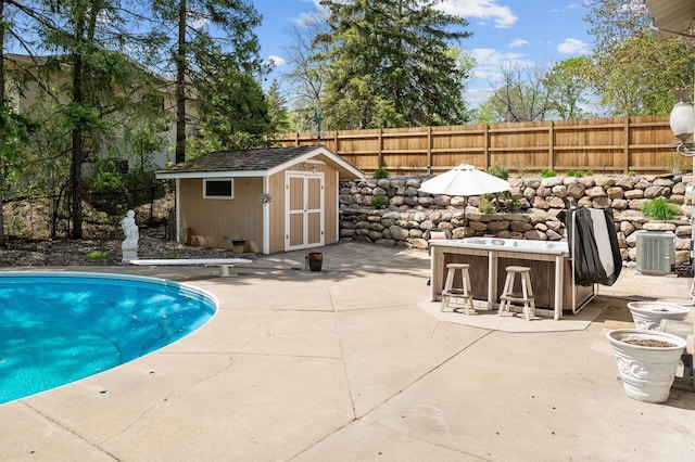 2209 Indian Rd W, Minnetonka, MN 55305 - view of swimming pool with a patio, a fenced backyard, a diving board, and central AC