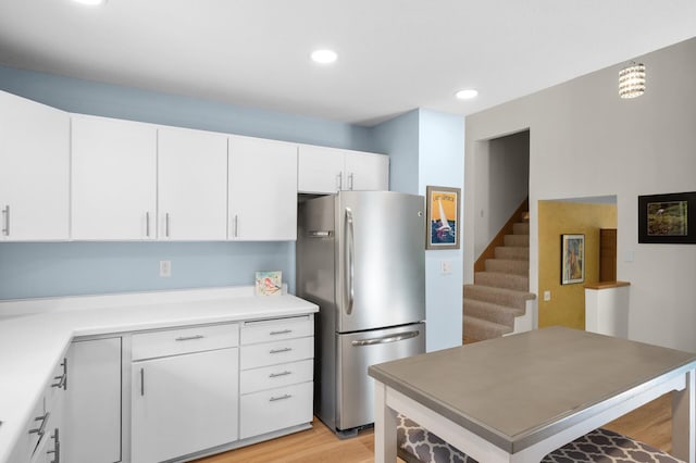 2209 Indian Rd W, Minnetonka, MN 55305 - kitchen featuring freestanding refrigerator, white cabinetry, light wood finished floors, recessed lighting, and a center island