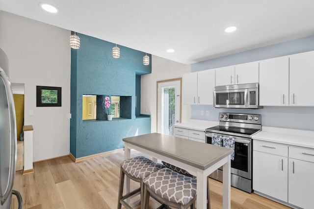 2209 Indian Rd W, Minnetonka, MN 55305 - kitchen featuring stainless steel appliances, light wood finished floors, white cabinets, baseboards, and recessed lighting