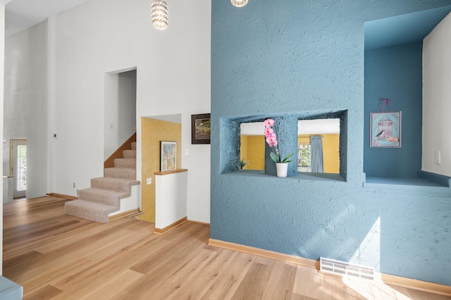 2209 Indian Rd W, Minnetonka, MN 55305 - staircase featuring wood finished floors, plenty of natural light, baseboards, and a high ceiling