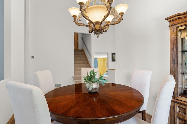 2209 Indian Rd W, Minnetonka, MN 55305 - dining space featuring a chandelier, stairs, and baseboards