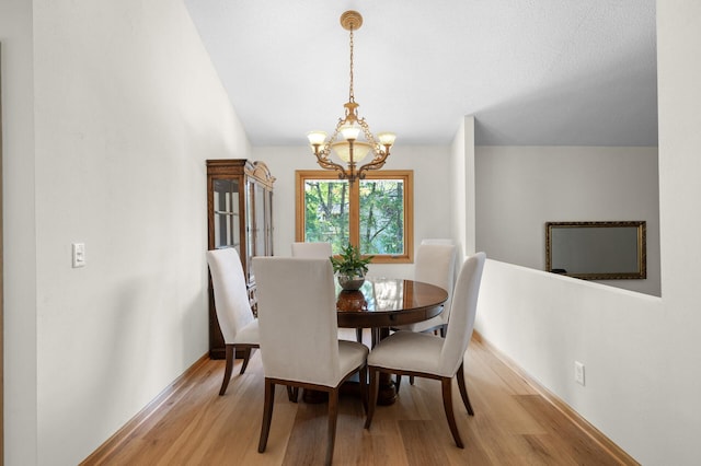 2209 Indian Rd W, Minnetonka, MN 55305 - dining area featuring a chandelier, light wood finished floors, and baseboards