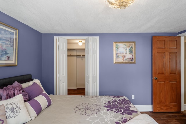 2209 Indian Rd W, Minnetonka, MN 55305 - bedroom with wood finished floors, a textured ceiling, a closet, and baseboards