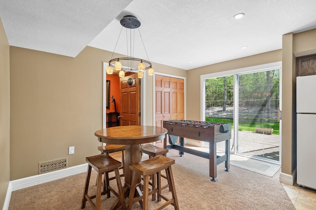 2209 Indian Rd W, Minnetonka, MN 55305 - dining room featuring baseboards, light colored carpet, and a textured ceiling