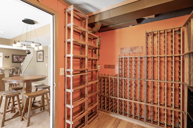 2209 Indian Rd W, Minnetonka, MN 55305 - wine room featuring wood finished floors and a chandelier