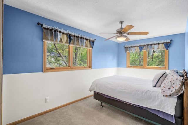 2209 Indian Rd W, Minnetonka, MN 55305 - carpeted bedroom featuring a textured ceiling, a ceiling fan, and baseboards