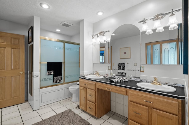 2209 Indian Rd W, Minnetonka, MN 55305 - full bath with double vanity, tile patterned flooring, toilet, a textured ceiling, and recessed lighting