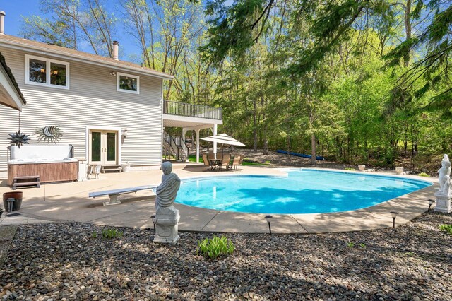 2209 Indian Rd W, Minnetonka, MN 55305 - swimming pool with french doors, a patio area, a diving board, and outdoor dining area