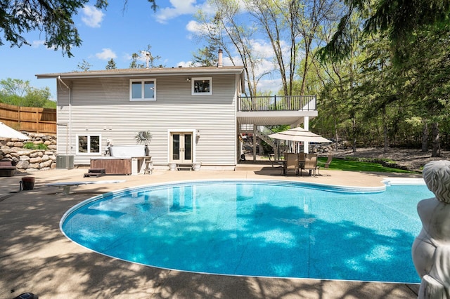 2209 Indian Rd W, Minnetonka, MN 55305 - outdoor pool with french doors, a patio, central AC unit, and a hot tub