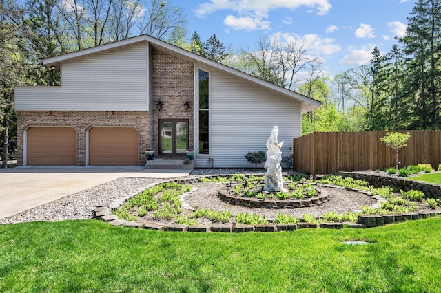 2209 Indian Rd W, Minnetonka, MN 55305 - view of front of house with an attached garage, brick siding, and concrete driveway