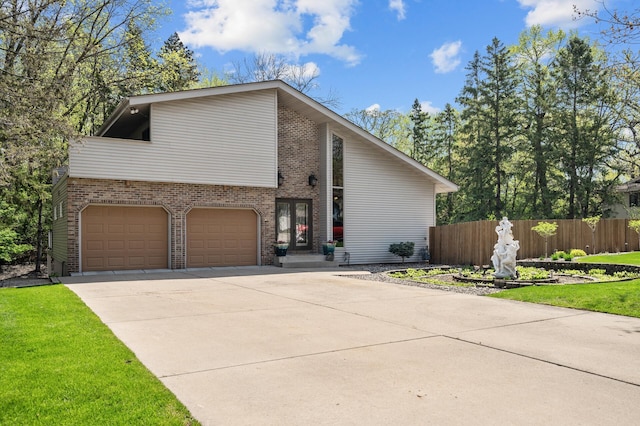 2209 Indian Rd W, Minnetonka, MN 55305 - mid-century modern home with an attached garage, brick siding, and driveway