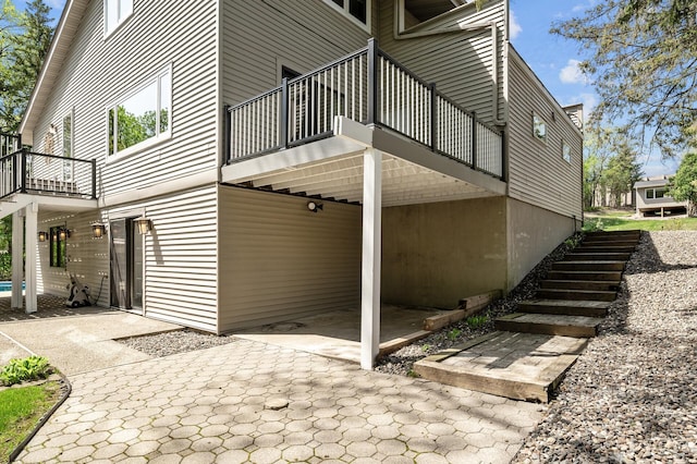 2209 Indian Rd W, Minnetonka, MN 55305 - view of home's exterior featuring a balcony and a patio