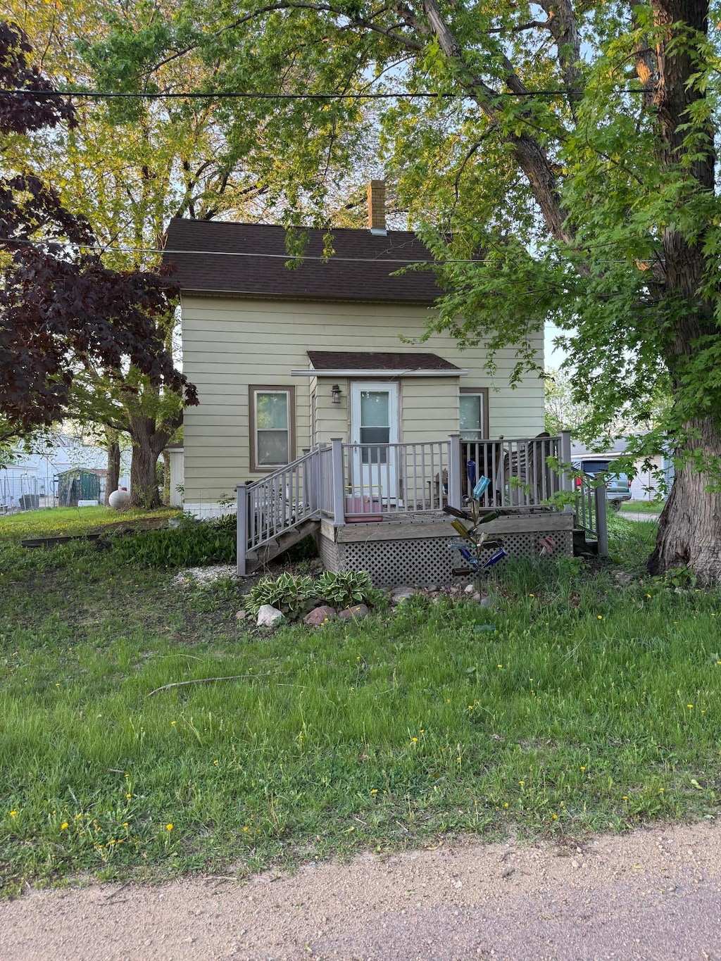112 3rd St, Pemberton, MN 56078 - view of front facade featuring a wooden deck and a chimney