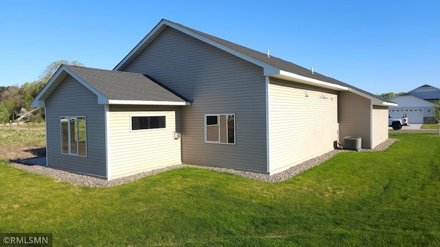 3137 Zuni Way NW, Anoka, MN 55303 - rear view of house with cooling unit, a lawn, and roof with shingles