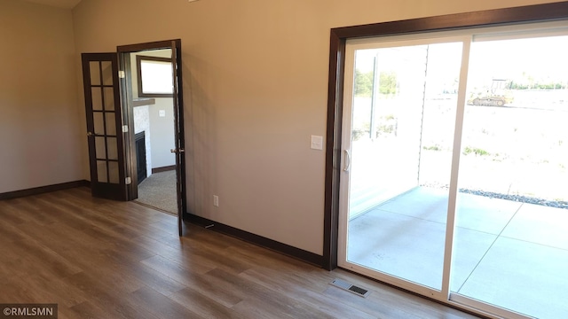 3137 Zuni Way NW, Anoka, MN 55303 - doorway to outside featuring dark wood-type flooring and baseboards