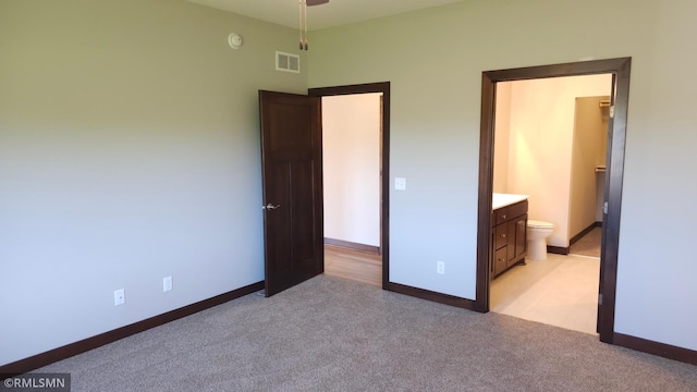 3137 Zuni Way NW, Anoka, MN 55303 - unfurnished bedroom with light carpet, baseboards, and ensuite bathroom