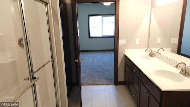 3137 Zuni Way NW, Anoka, MN 55303 - full bath with double vanity, an enclosed shower, baseboards, and tile patterned flooring