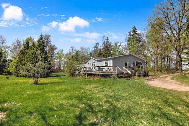 7210 79th Ave SW, Staples, MN 56479 - view of green lawn featuring a wooden deck and dirt driveway