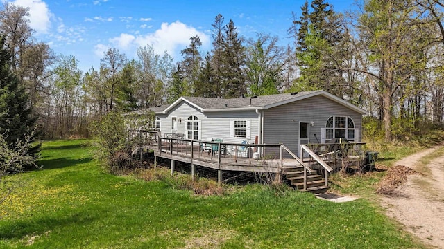 7210 79th Ave SW, Staples, MN 56479 - rear view of house with a lawn and a deck