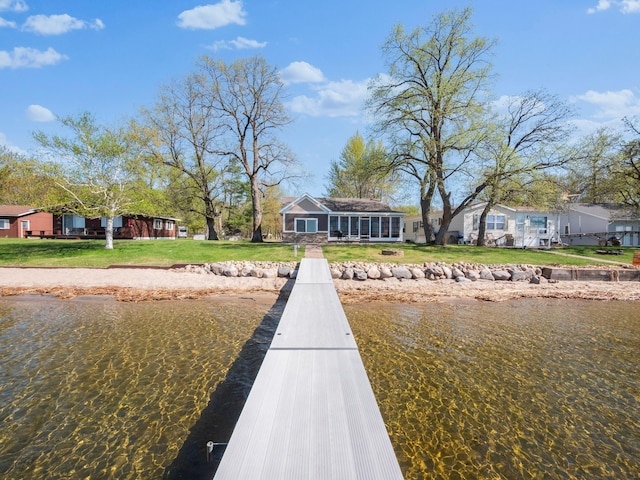dock area featuring a lawn and a water view