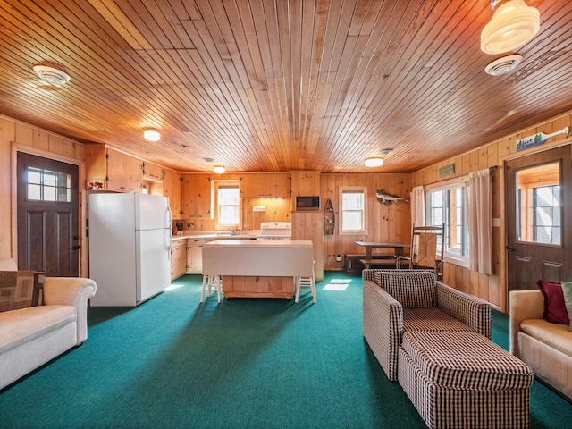 rec room featuring a sink, dark colored carpet, wooden walls, plenty of natural light, and wooden ceiling