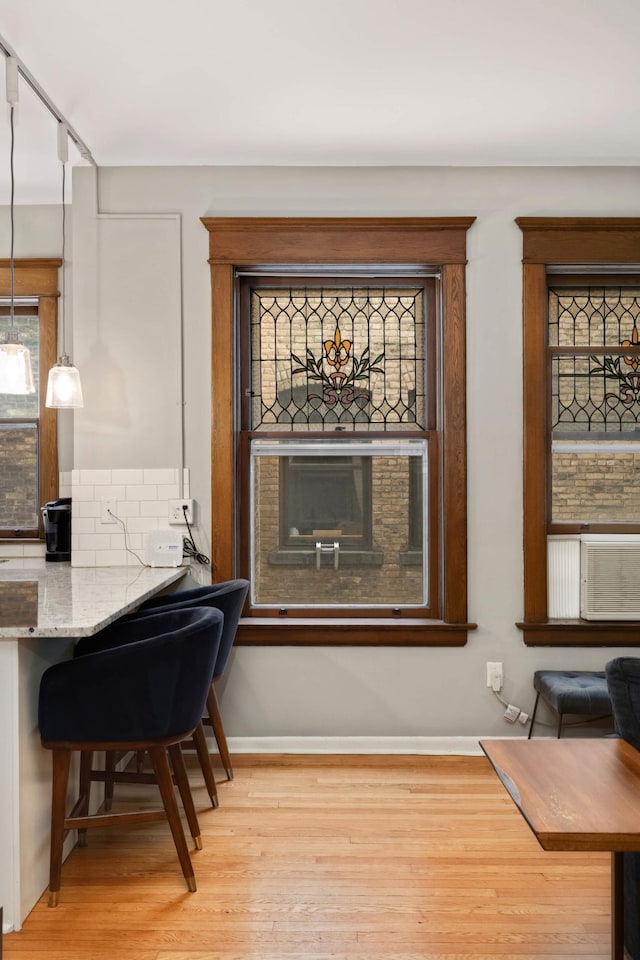 635 Grand Ave Unit 4, Saint Paul, MN 55105 - detailed view of wood finished floors, cooling unit, and baseboards