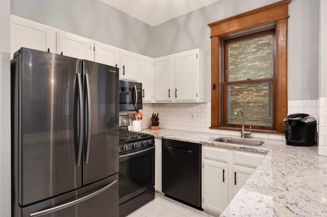 635 Grand Ave Unit 4, Saint Paul, MN 55105 - kitchen featuring black appliances, a sink, light stone countertops, white cabinets, and decorative backsplash