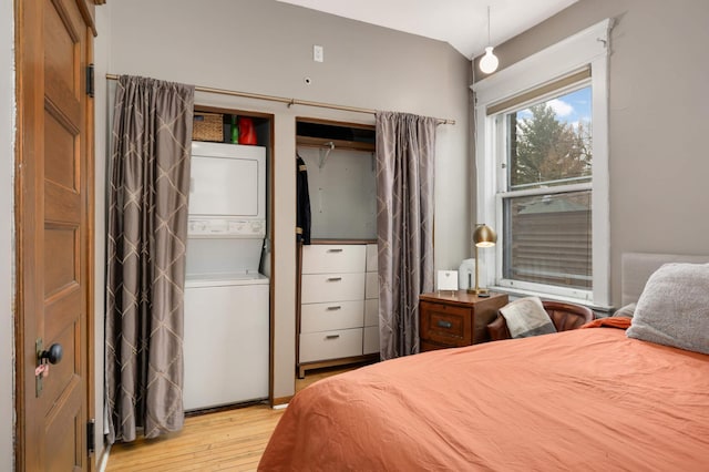 635 Grand Ave Unit 4, Saint Paul, MN 55105 - bedroom with estacked washer and dryer and hardwood / wood-style flooring