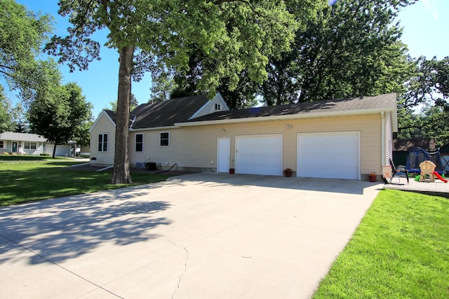 340 5th Ave SW, Hutchinson, MN 55350 - view of front facade with a front lawn, concrete driveway, a garage, and a playground