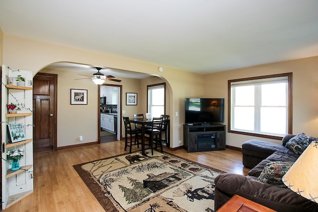 340 5th Ave SW, Hutchinson, MN 55350 - living area featuring arched walkways, ceiling fan, plenty of natural light, and light wood-type flooring