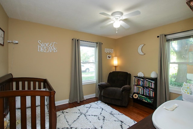 340 5th Ave SW, Hutchinson, MN 55350 - bedroom with wood finished floors, a crib, and ceiling fan