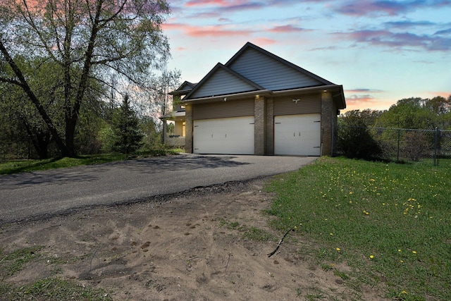25100 Lincoln Dr NE, Athens Twp, MN 55040 - property exterior at dusk with asphalt driveway and an attached garage