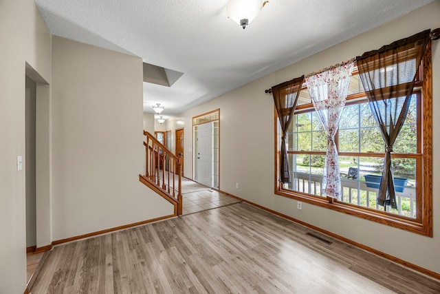 25100 Lincoln Dr NE, Athens Twp, MN 55040 - spare room featuring stairs, baseboards, and wood finished floors