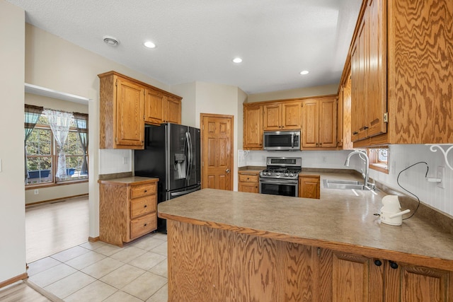 25100 Lincoln Dr NE, Athens Twp, MN 55040 - kitchen with stainless steel appliances, a sink, a peninsula, light tile patterned flooring, and recessed lighting