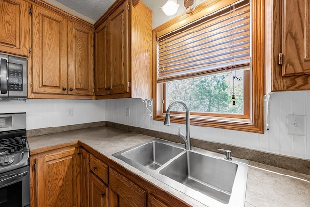 25100 Lincoln Dr NE, Athens Twp, MN 55040 - kitchen with stainless steel gas range, a sink, and brown cabinets