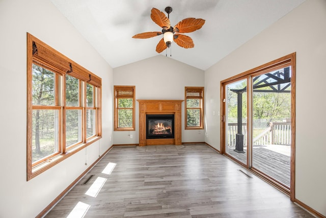 25100 Lincoln Dr NE, Athens Twp, MN 55040 - unfurnished living room with healthy amount of natural light, a ceiling fan, lofted ceiling, and wood finished floors