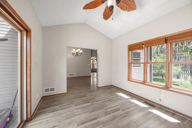 25100 Lincoln Dr NE, Athens Twp, MN 55040 - unfurnished room with a chandelier, healthy amount of natural light, ceiling fan, vaulted ceiling, and light wood-style flooring