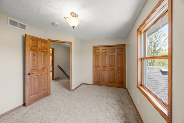 25100 Lincoln Dr NE, Athens Twp, MN 55040 - unfurnished bedroom with light colored carpet, a closet, and baseboards