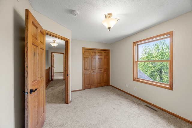 25100 Lincoln Dr NE, Athens Twp, MN 55040 - unfurnished bedroom with light carpet, a closet, baseboards, and a textured ceiling